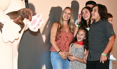 Jean Carmelo De Grazia gives a puppy to a new family during the screening of his recent film